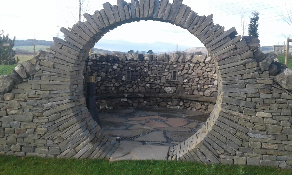 An image of a large round opening made entirely of stones pieced together without mortar.